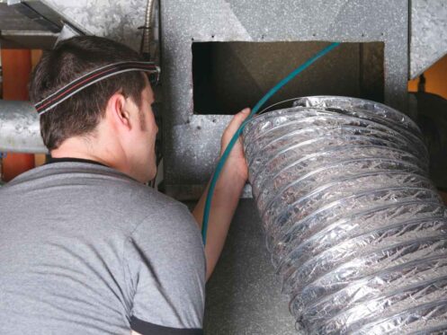 HVAC technician cleaning ductwork