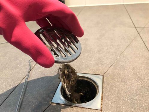 Clearing the shower drain due to a hair clog